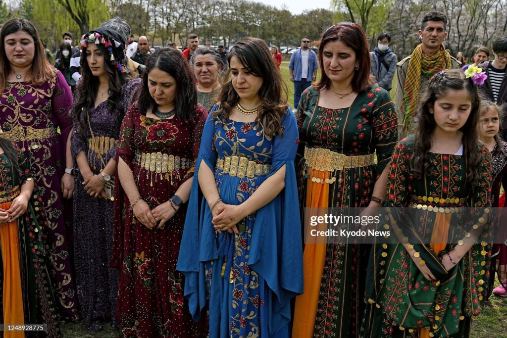 Kurdish people offer silent prayers for the victims of the February earthquake in Turkey and Syria during their traditional New Year holiday of Newroz in Saitama near Tokyo on March 21, 2023. Many Kurdish people living in Japan hail from the areas affected by the earthquake. (Photo by Kyodo News via Getty Images)