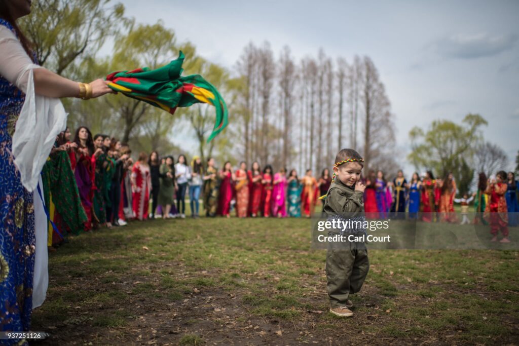TOKYO, JAPAN - MARCH 24:  A young Kurdish boy in traditional attire stands in a ring formed by Kurdish women as they dance during Nowruz celebrations on March 24, 2018 in Tokyo, Japan. Nowruz meaning 'new day' and marking the first day of spring, is widely celebrated by Kurdish communities around the world including in Japan where an estimated 2000 Kurds reside, many of whom are claiming refugee status owing to alleged human rights abuses in Turkey and Iraq. Although the Japanese government has issued some temporary permits allowing many to stay for years, no Turkish Kurd has ever been received refugee status in Japan, which would allow them to settle permanently. (Photo by Carl Court/Getty Images)