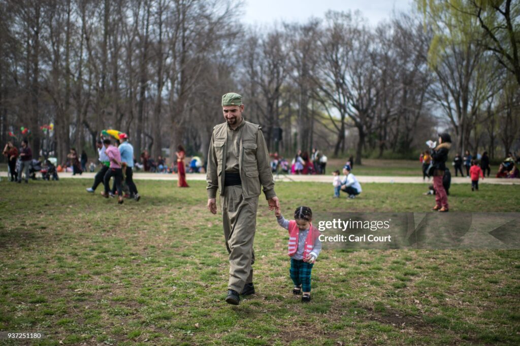 TOKYO, JAPAN - MARCH 24:  A Kurdish man in traditional attire walks with a young child during Nowruz celebrations on March 24, 2018 in Tokyo, Japan. Nowruz meaning 'new day' and marking the first day of spring, is widely celebrated by Kurdish communities around the world including in Japan where an estimated 2000 Kurds reside, many of whom are claiming refugee status owing to alleged human rights abuses in Turkey and Iraq. Although the Japanese government has issued some temporary permits allowing many to stay for years, no Turkish Kurd has ever been received refugee status in Japan, which would allow them to settle permanently. (Photo by Carl Court/Getty Images)