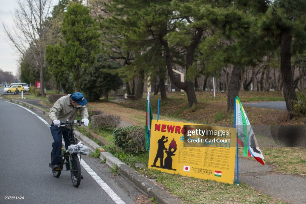 TOKYO, JAPAN - MARCH 24:  A Japanese man pauses to read a sign informing people about the event during Nowruz celebrations on March 24, 2018 in Tokyo, Japan. Nowruz meaning 'new day' and marking the first day of spring, is widely celebrated by Kurdish communities around the world including in Japan where an estimated 2000 Kurds reside, many of whom are claiming refugeeæstatus owing to alleged human rights abuses in Turkey and Iraq. Although the Japanese government has issued some temporary permits allowing many to stay for years, no Turkish Kurd has ever been received refugee status in Japan, which would allow them to settle permanently.æ(Photo by Carl Court/Getty Images)