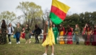 TOKYO, JAPAN - MARCH 24:  A young girl waves the flag of the Democratic Federation of Northern Syria during Nowruz celebrations on March 24, 2018 in Tokyo, Japan. Nowruz meaning 'new day' and marking the first day of spring, is widely celebrated by Kurdish communities around the world including in Japan where an estimated 2000 Kurds reside, many of whom are claiming refugeeæstatus owing to alleged human rights abuses in Turkey and Iraq. Although the Japanese government has issued some temporary permits allowing many to stay for years, no Turkish Kurd has ever been received refugee status in Japan, which would allow them to settle permanently.æ  (Photo by Carl Court/Getty Images)